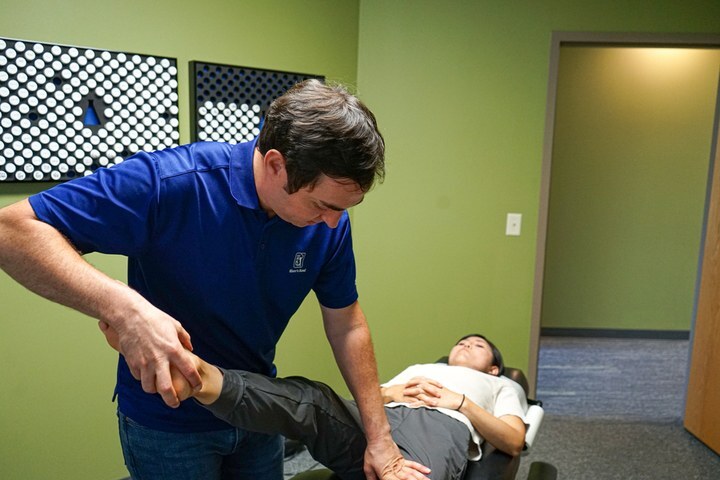 Chiropractor lifting a patient's leg