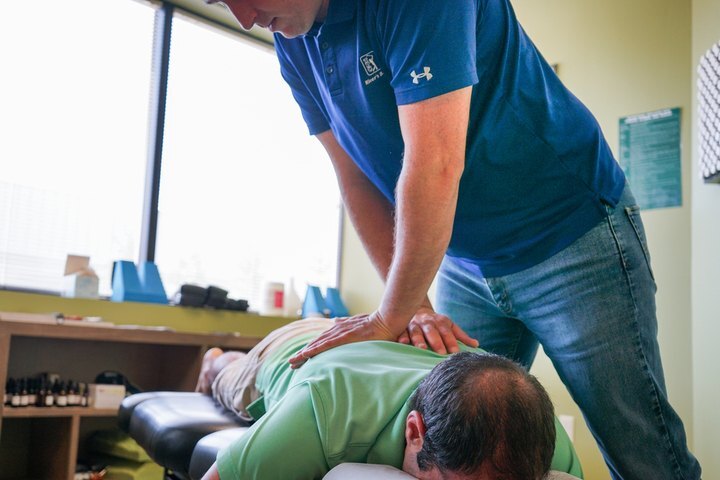 Man performing chiropractic treatment on a patient